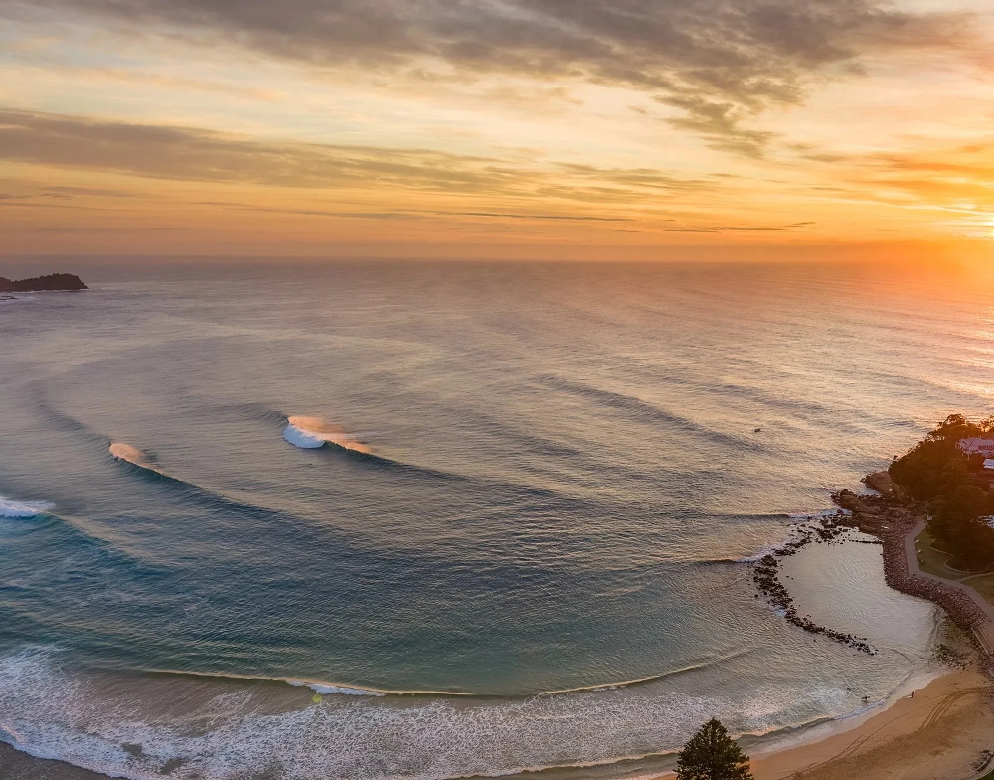 Avoca Beach sunrise aerial view with clean rolling waves and golden light – Central Coast NSW