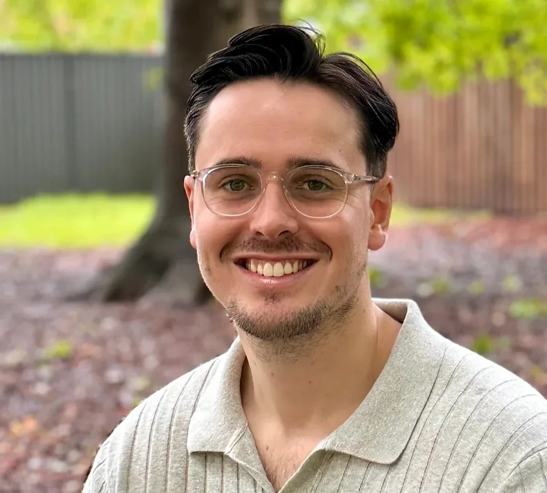 James Wightman, psychologist at MindSure Psychology in Gosford on the Central Coast, sitting outdoors and smiling